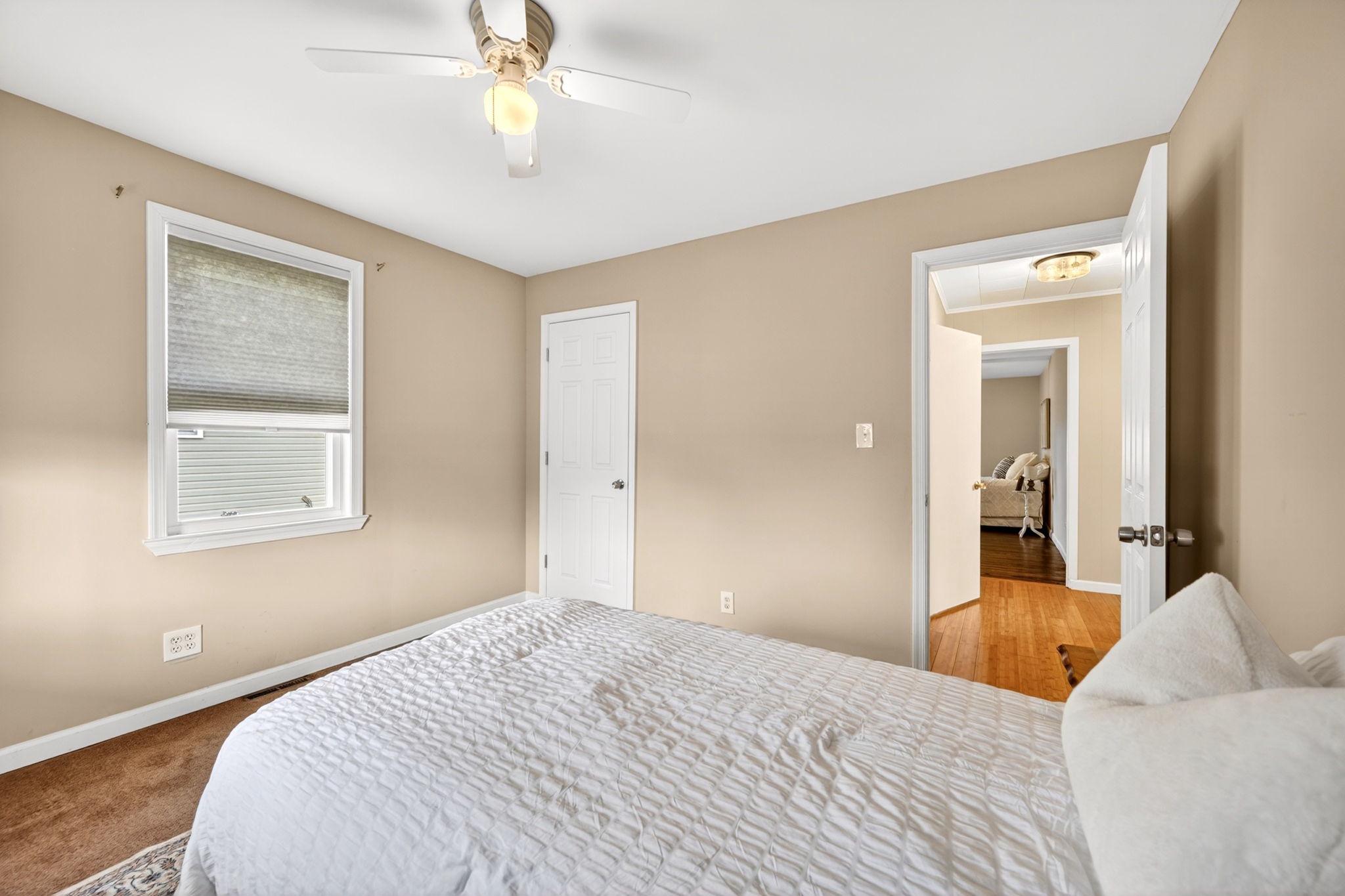206 South Woodwell Road Baltimore, MD 21222 - Photo 23 of 46 a bedroom with a bed and a chandelier