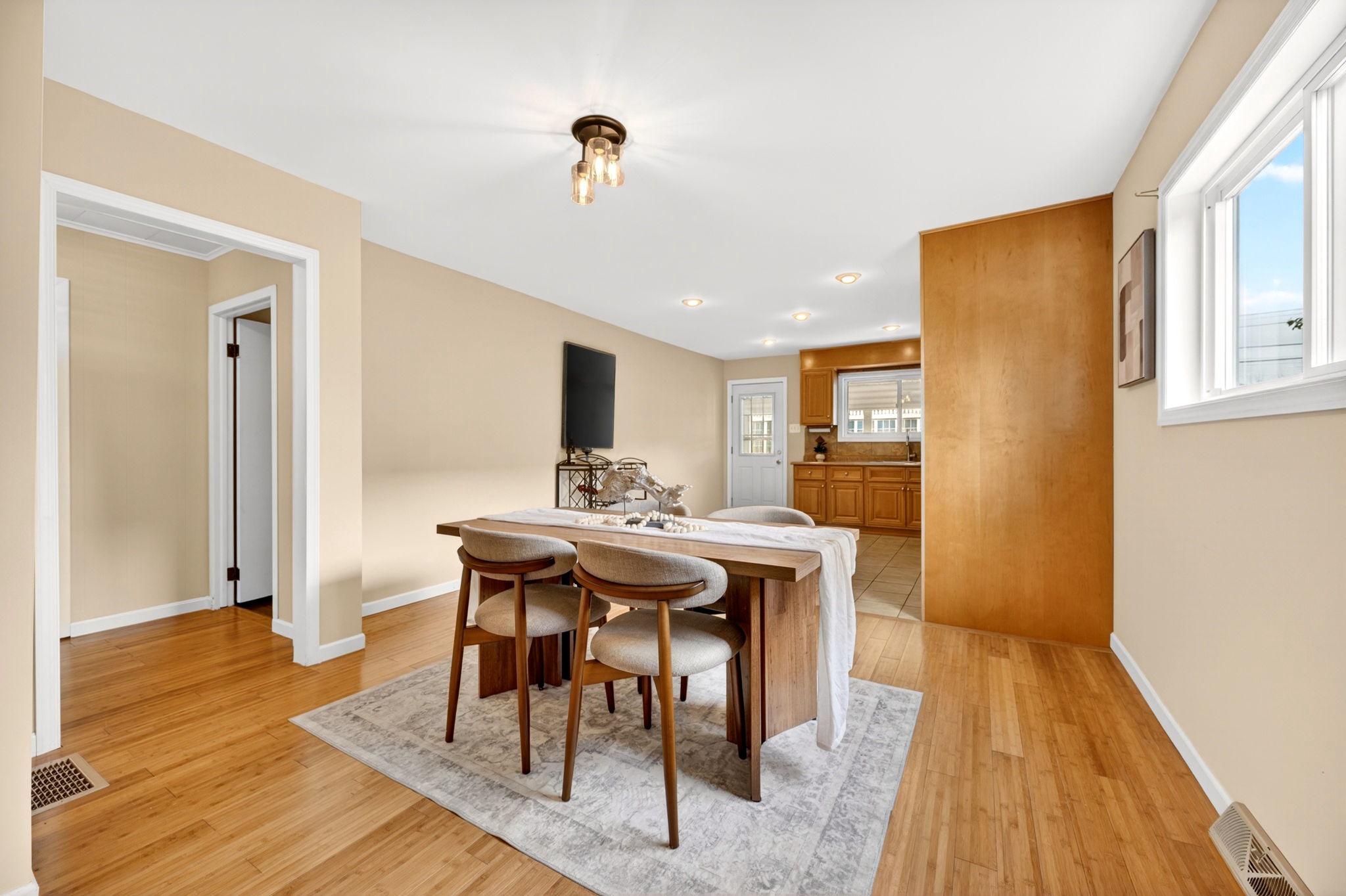 206 South Woodwell Road Baltimore, MD 21222 - Photo 7 of 46 a view of a dining room with furniture window and wooden floor
