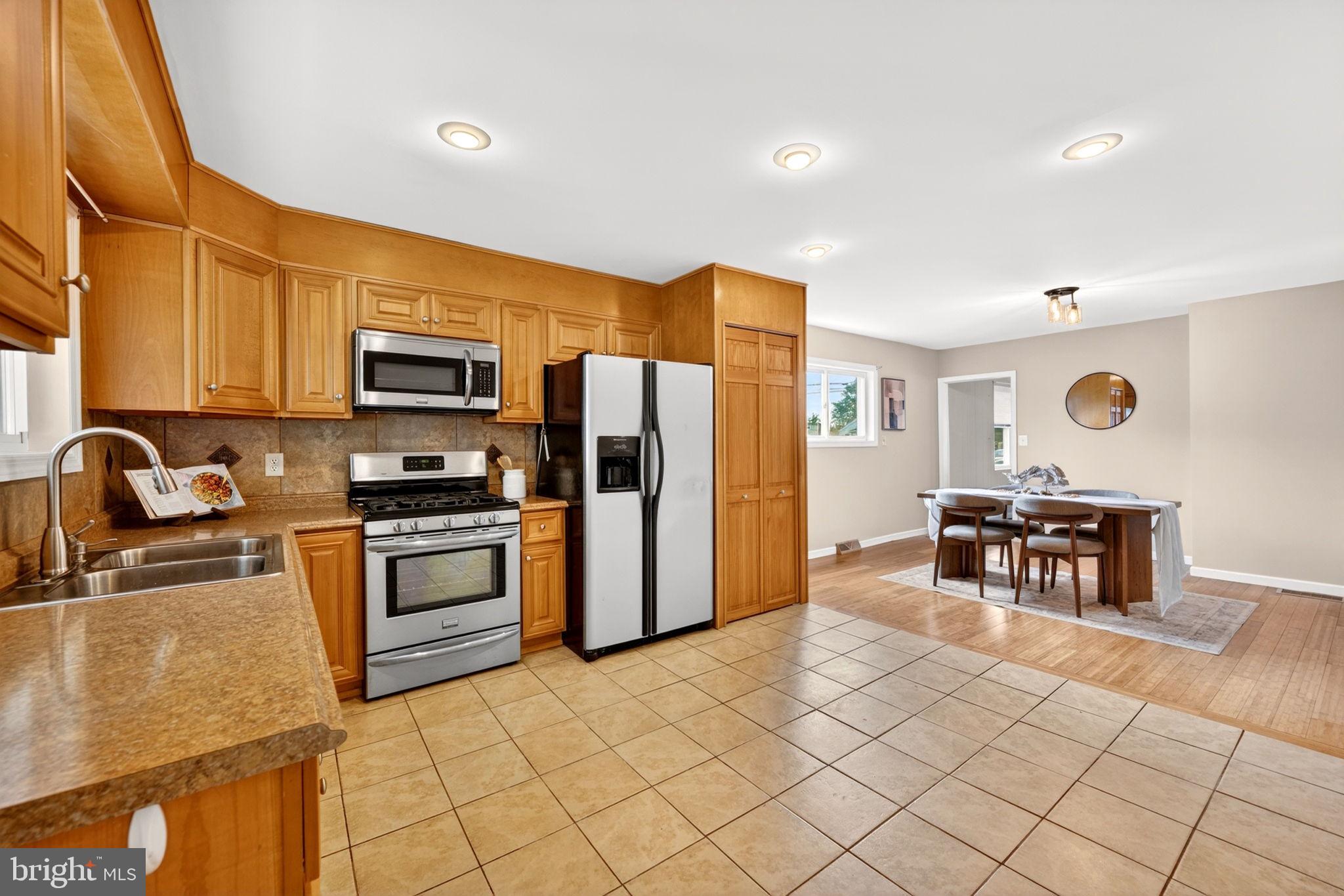 206 South Woodwell Road Baltimore, MD 21222 - Photo 10 of 46 a kitchen with kitchen island granite countertop a stove cabinets and refrigerator