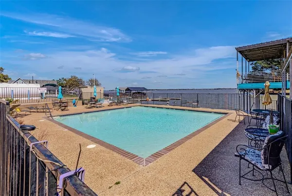 a view of a house with swimming pool and sitting area