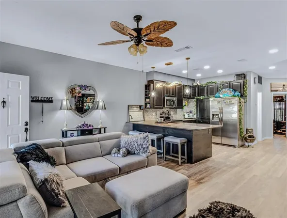 a kitchen with stainless steel appliances granite countertop a sink a stove and a wooden floors