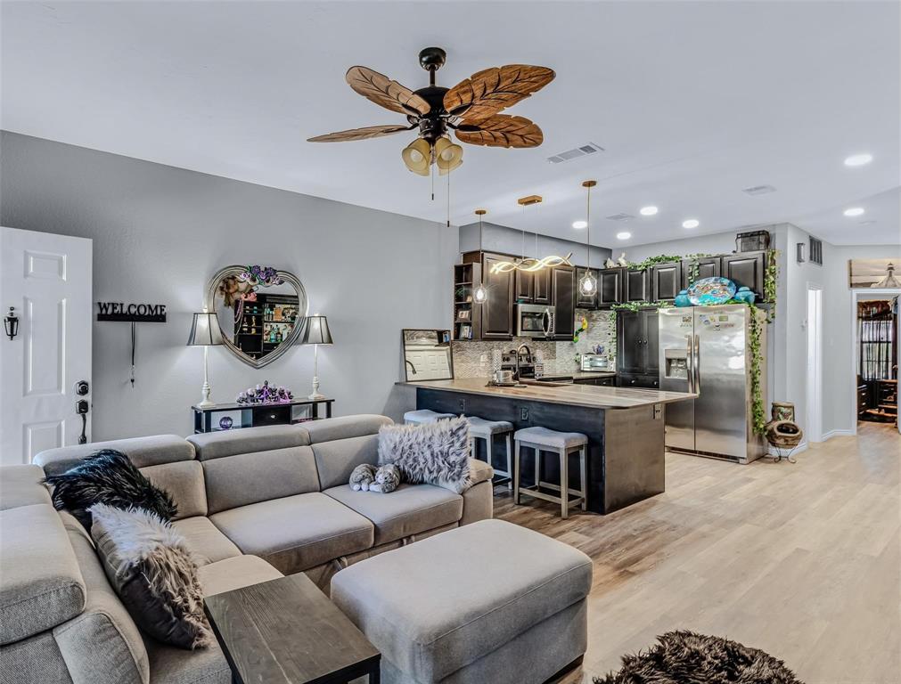 1933 Island Circle, Unit B106 Tool, TX 75143 - Photo 5 of 12 a living room with furniture kitchen view and a chandelier