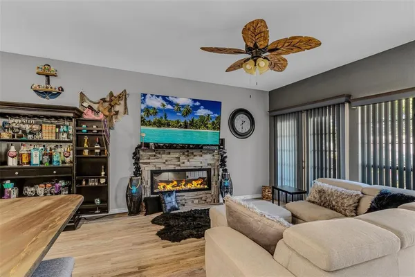 a living room with furniture kitchen view and a chandelier