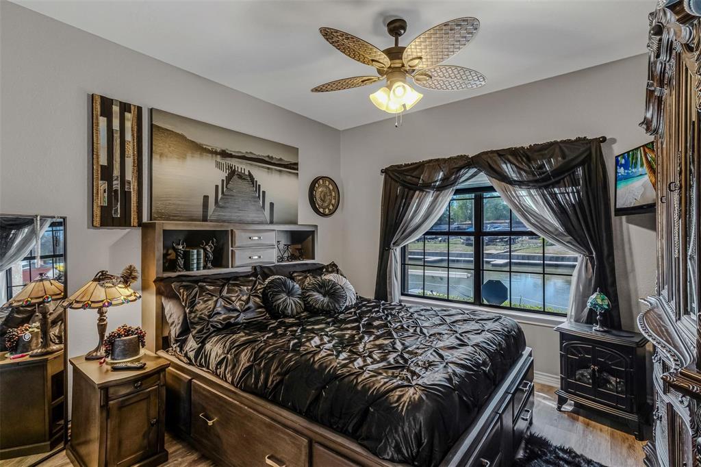 1933 Island Circle, Unit B106 Tool, TX 75143 - Photo 7 of 12 a bedroom with a bed next to a window and a flat tv screen