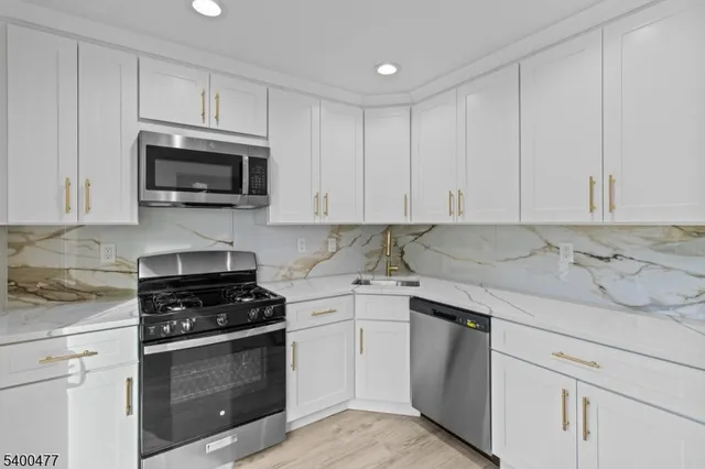 a kitchen with cabinets stainless steel appliances and cabinets