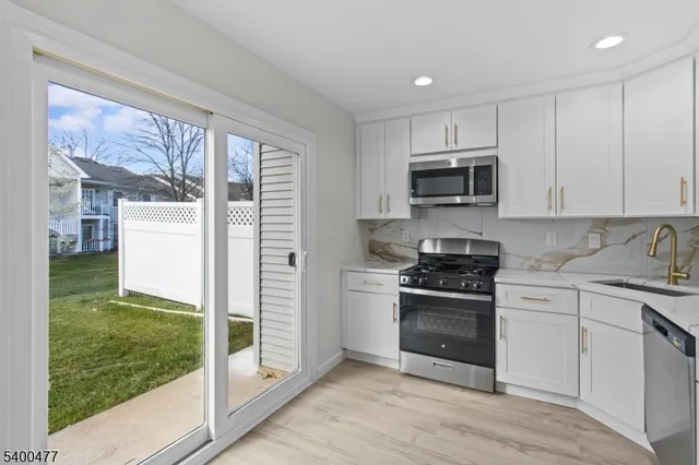 a kitchen with a stove a sink and a microwave
