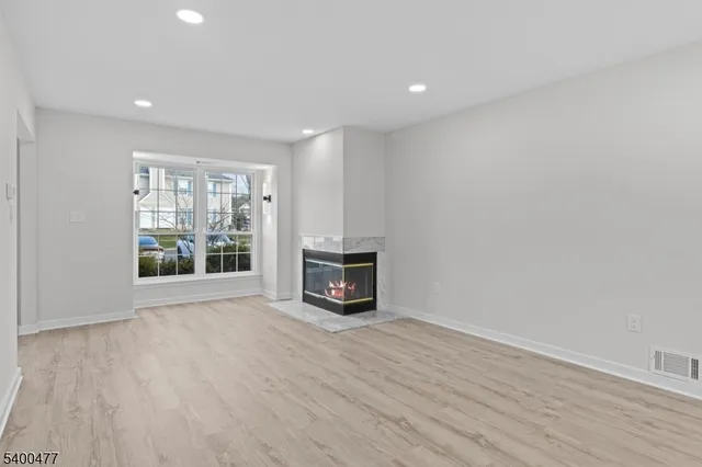 a room with a fireplace and a window