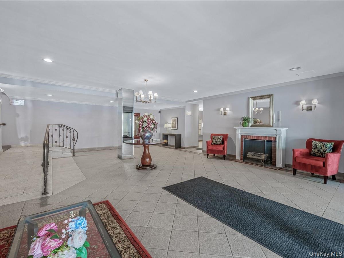 241-20 Northern Boulevard, Unit 6M Queens, NY 11362 - Photo 11 of 18 a living room with furniture and a fireplace