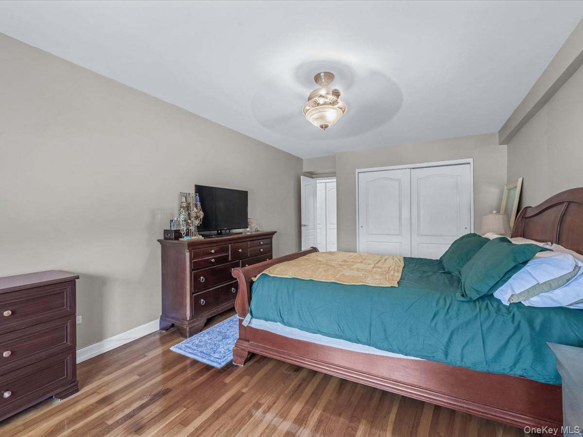 241-20 Northern Boulevard, Unit 6M Queens, NY 11362 - Photo 7 of 18 a bedroom with a bed and flat screen tv