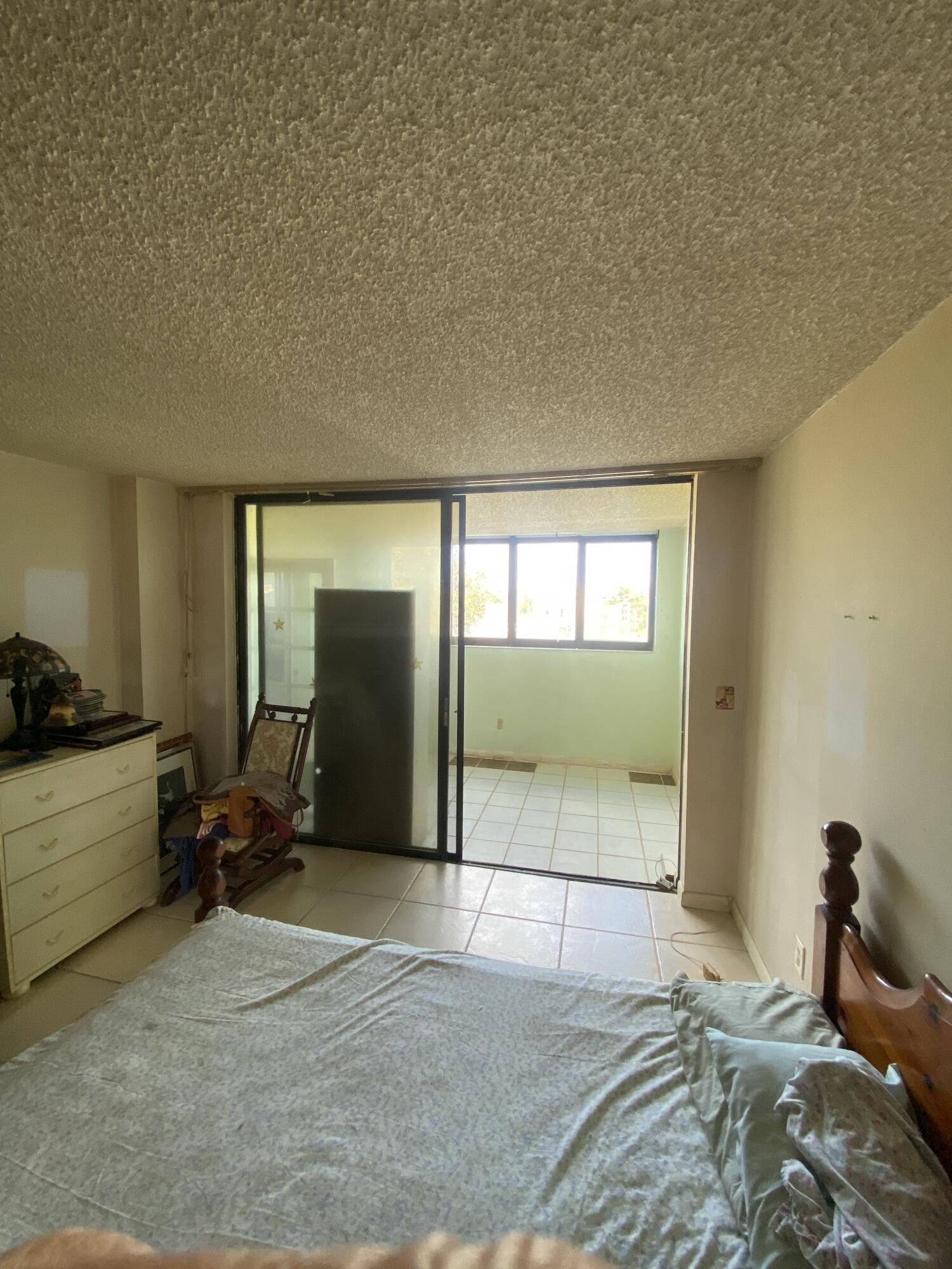 755 Dotterel Road, Unit 1304 Delray Beach, FL 33444 - Photo 13 of 21 Primary Bedroom to enclosed patio
