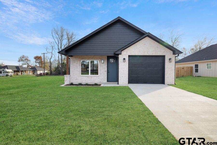 a front view of house with yard and green space