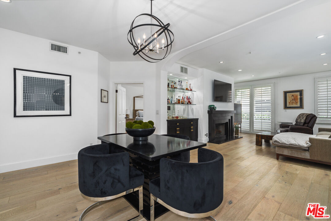 11740 Sunset Boulevard, Unit 14 Los Angeles, CA 90049 - Photo 15 of 44 a living room with furniture a fireplace and a flat screen tv