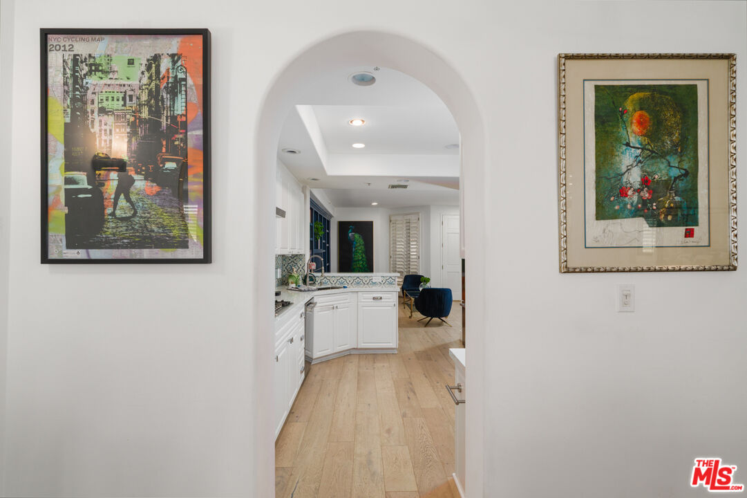 11740 Sunset Boulevard, Unit 14 Los Angeles, CA 90049 - Photo 16 of 44 a view of a hallway with wooden floor and a living room