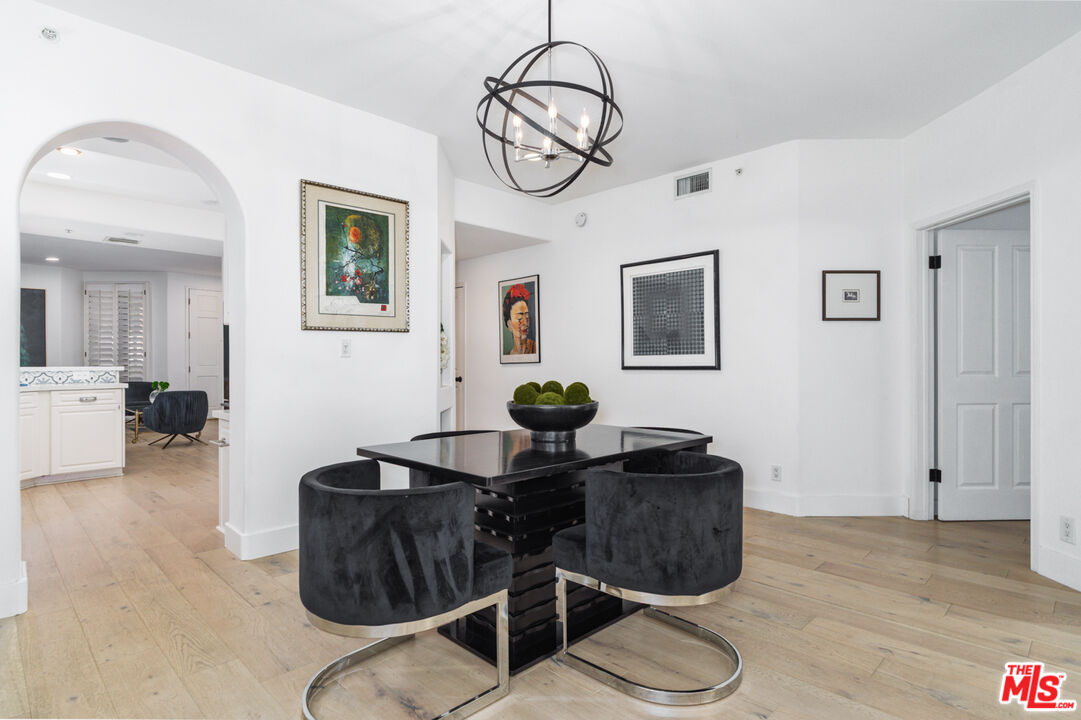 11740 Sunset Boulevard, Unit 14 Los Angeles, CA 90049 - Photo 17 of 44 a living room with furniture potted plant and a window