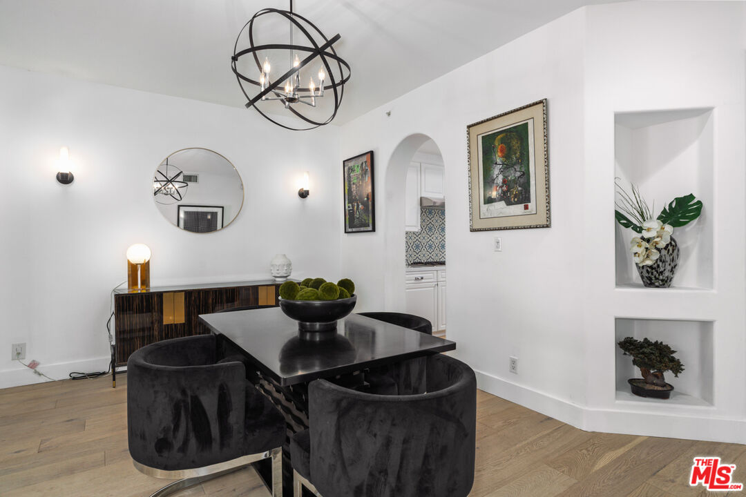 11740 Sunset Boulevard, Unit 14 Los Angeles, CA 90049 - Photo 18 of 44 a table and a vase of flowers sitting on a table with wooden floor