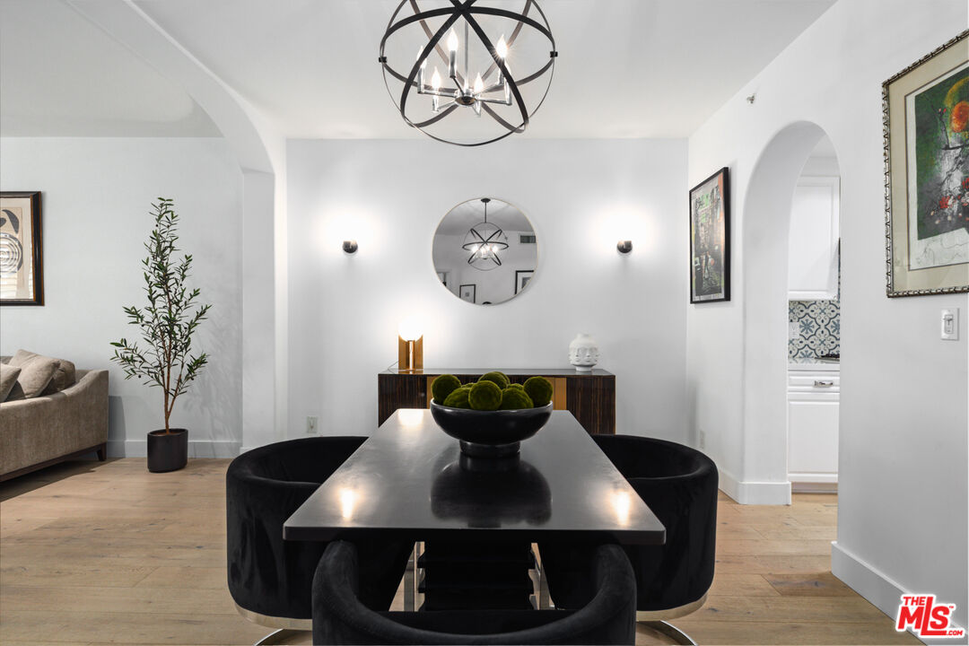 11740 Sunset Boulevard, Unit 14 Los Angeles, CA 90049 - Photo 19 of 44 a view of a dining room with furniture and wooden floor