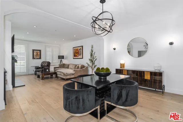 a bed sitting in a spacious bedroom next to a window