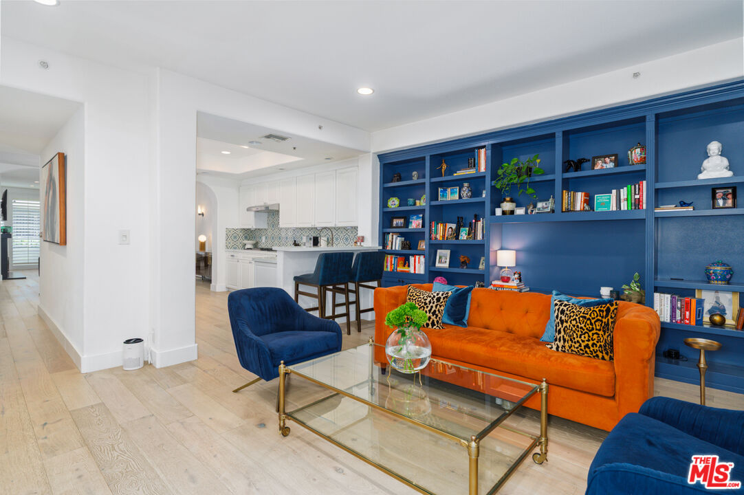 11740 Sunset Boulevard, Unit 14 Los Angeles, CA 90049 - Photo 2 of 44 a living room with furniture and a book shelf