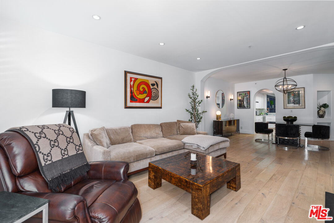 11740 Sunset Boulevard, Unit 14 Los Angeles, CA 90049 - Photo 24 of 44 a living room with furniture and wooden floor