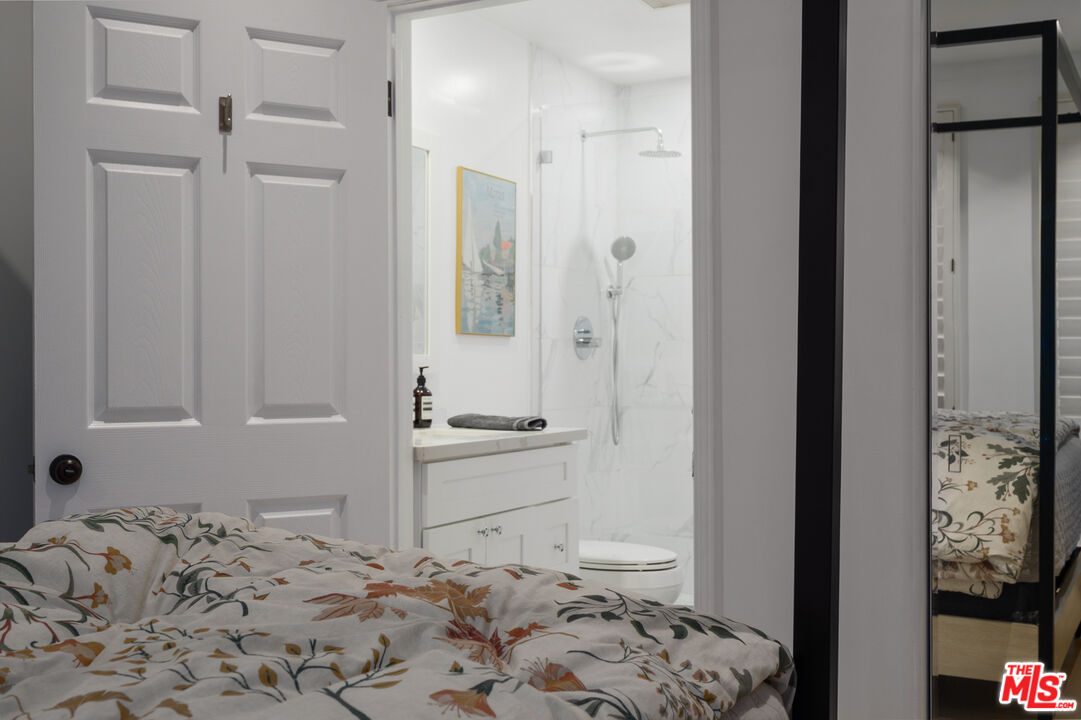 11740 Sunset Boulevard, Unit 14 Los Angeles, CA 90049 - Photo 35 of 44 a bathroom with a sink and a mirror