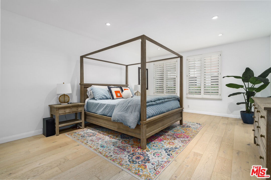 11740 Sunset Boulevard, Unit 14 Los Angeles, CA 90049 - Photo 37 of 44 a bedroom with a bed and a window