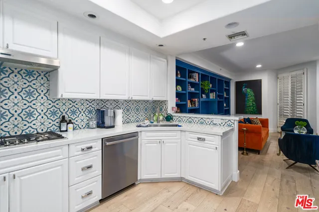 a living room with furniture and a view of kitchen