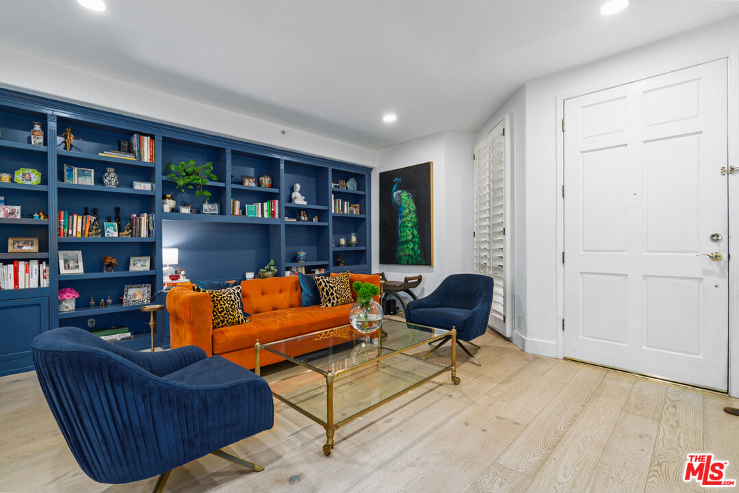 11740 Sunset Boulevard, Unit 14 Los Angeles, CA 90049 - Photo 5 of 44 a living room with furniture and a book shelf