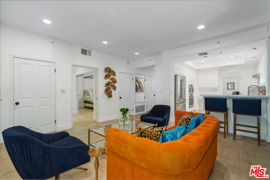 11740 Sunset Boulevard, Unit 14 Los Angeles, CA 90049 - Photo 8 of 44 a living room with furniture and a view of kitchen