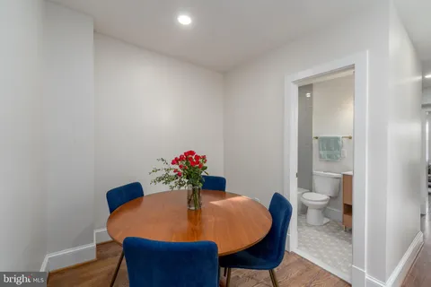 a dining room with furniture and wooden floor