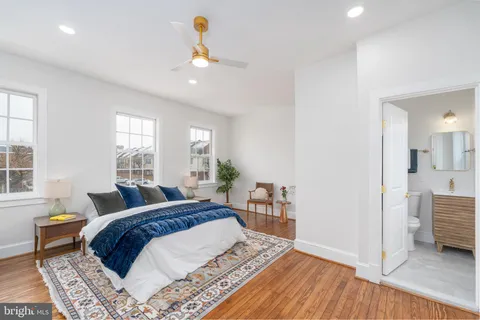 a spacious bedroom with a bed a window and walk in closet