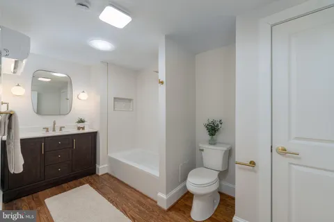 a bathroom with a toilet a sink and mirror