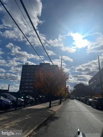 a view of a street with a building in the background