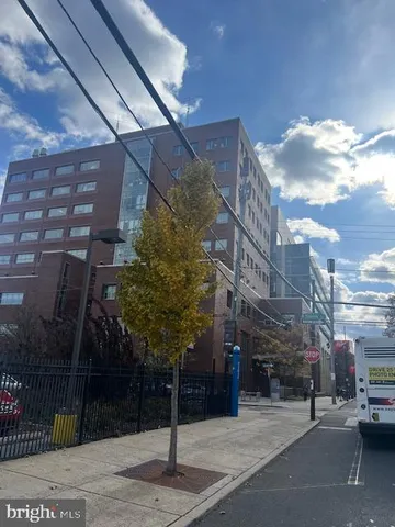 a street sign on a sidewalk next to a building
