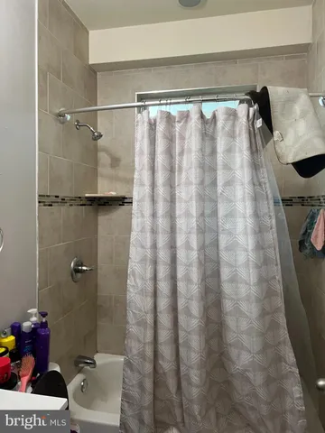 a bathroom with a shower curtain and a sink