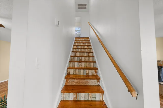 a view of bedroom with wooden floor