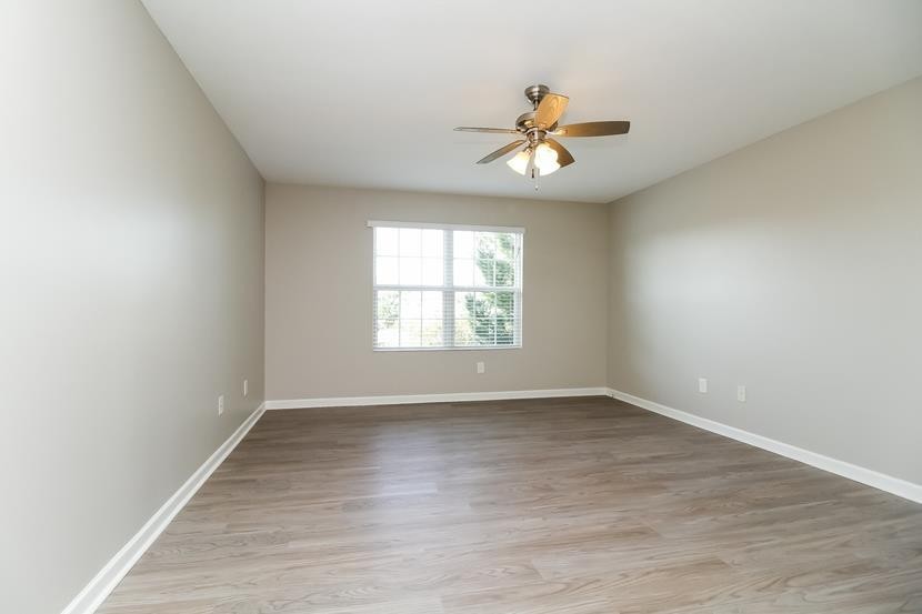 3704 Blaze Drive Murfreesboro, TN 37128 - Photo 15 of 17 an empty room with wooden floor fan and windows