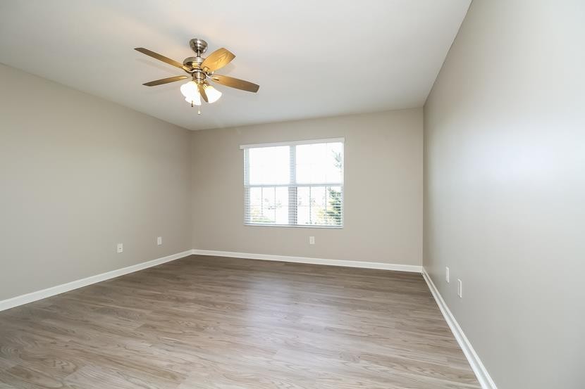 3704 Blaze Drive Murfreesboro, TN 37128 - Photo 16 of 17 an empty room with wooden floor fan and windows
