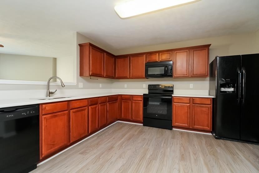 3704 Blaze Drive Murfreesboro, TN 37128 - Photo 8 of 17 a kitchen with granite countertop wooden floors a refrigerator and a sink