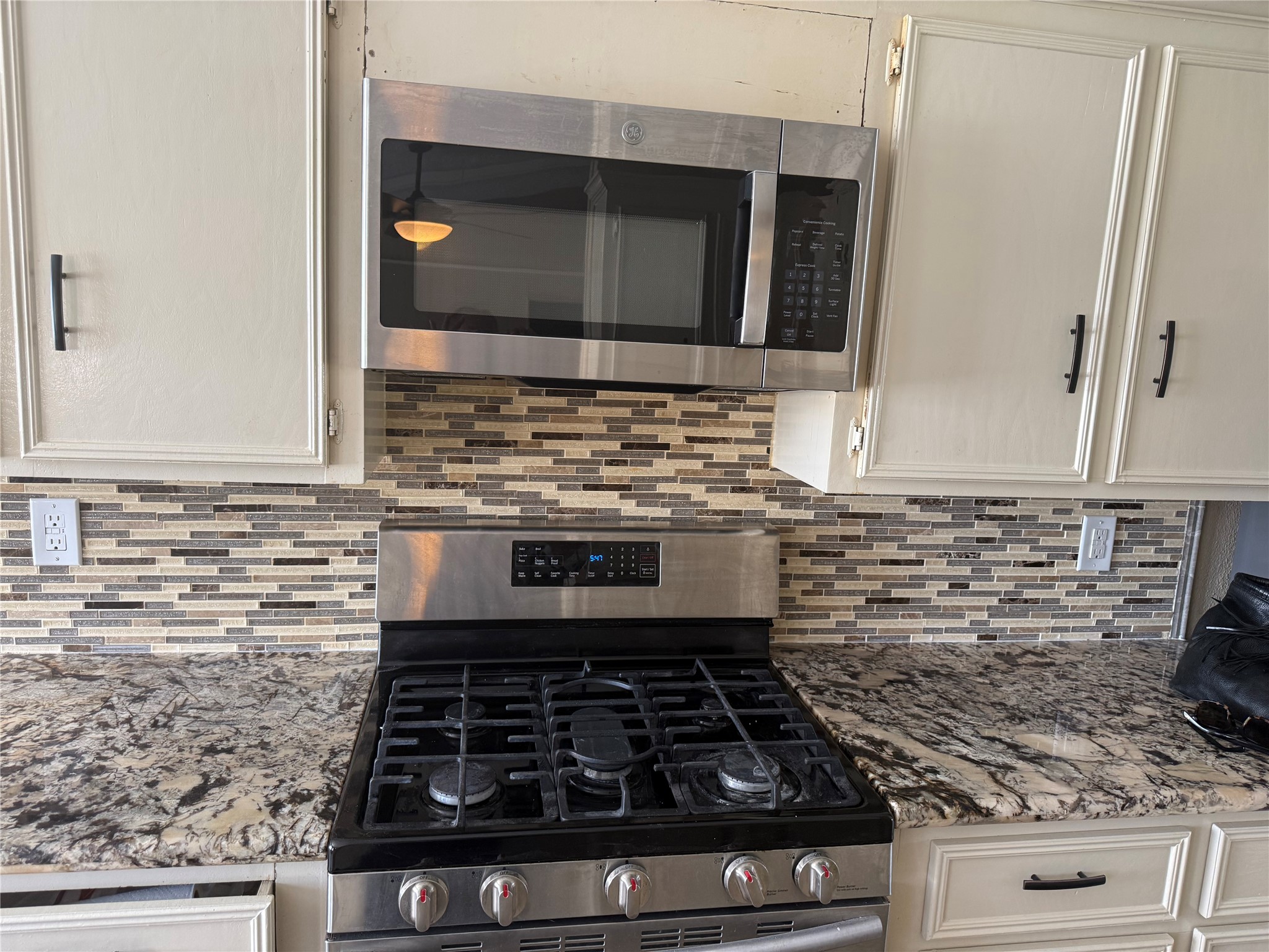 13726 Rampchester Lane Houston, TX 77015 - Photo 17 of 30 a kitchen with granite countertop a stove and a microwave
