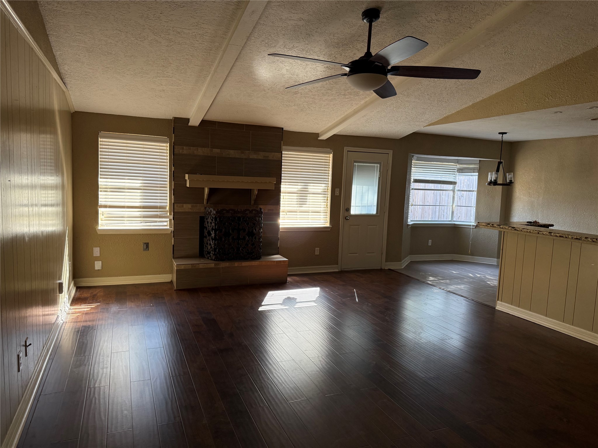 13726 Rampchester Lane Houston, TX 77015 - Photo 2 of 15 an empty room with wooden floor fireplace and windows