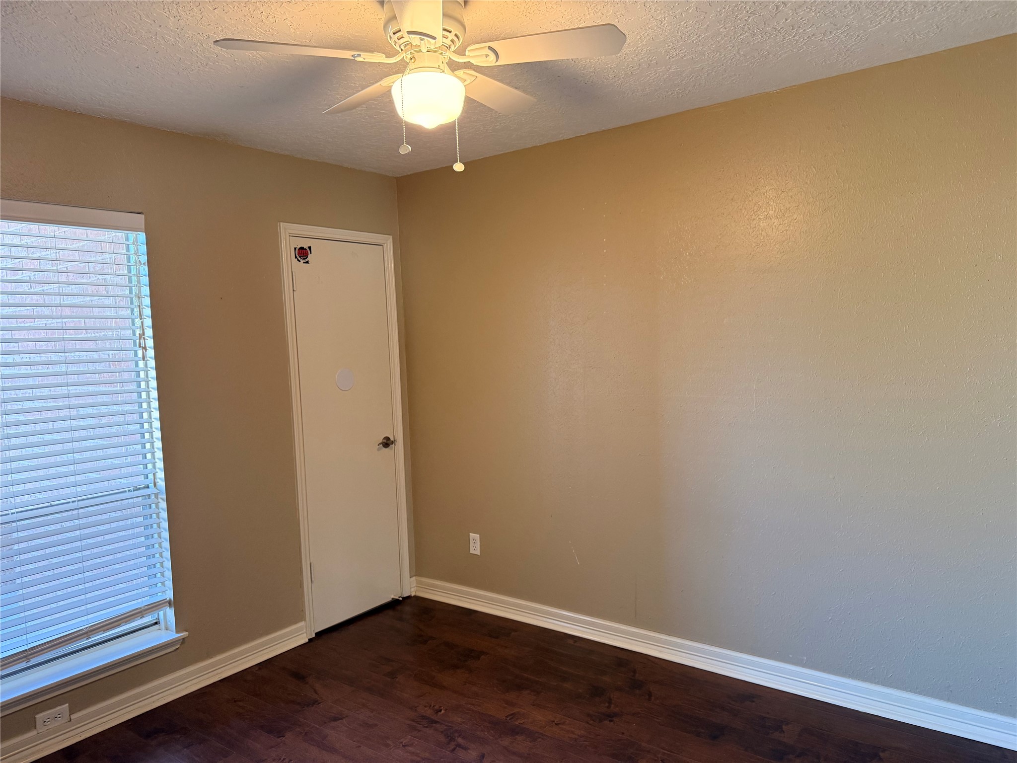 13726 Rampchester Lane Houston, TX 77015 - Photo 25 of 30 an empty room with wooden floor and fan