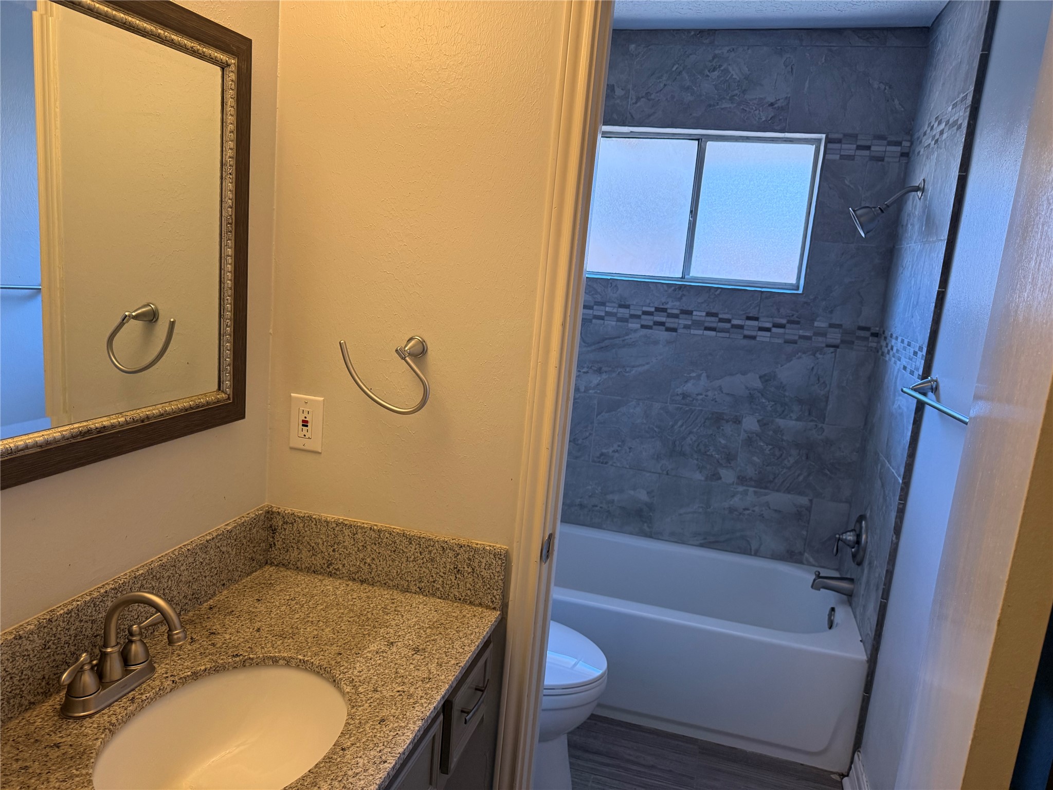 13726 Rampchester Lane Houston, TX 77015 - Photo 26 of 30 a bathroom with a granite countertop sink toilet and shower