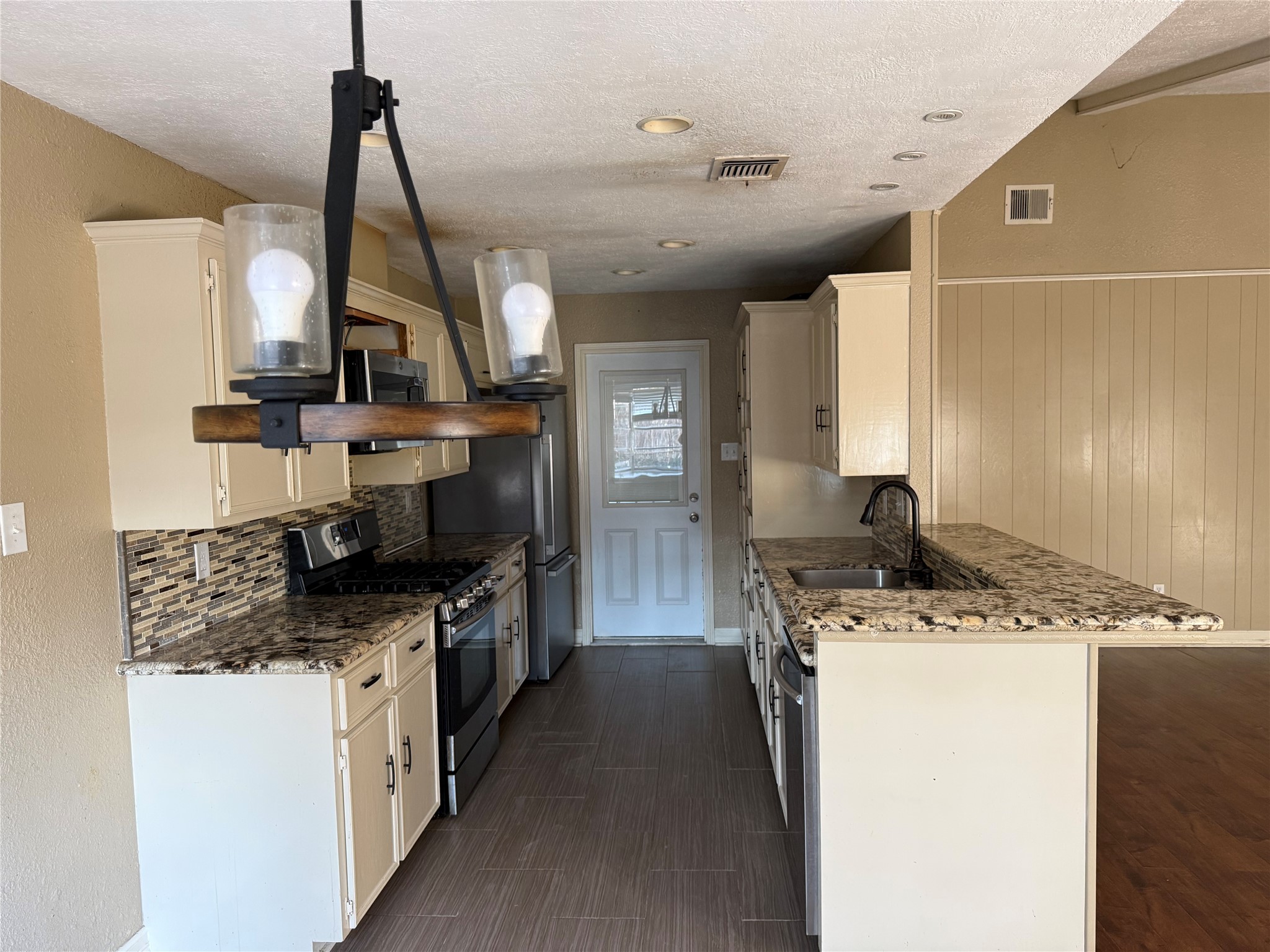 13726 Rampchester Lane Houston, TX 77015 - Photo 7 of 30 a kitchen with a sink stove and cabinets