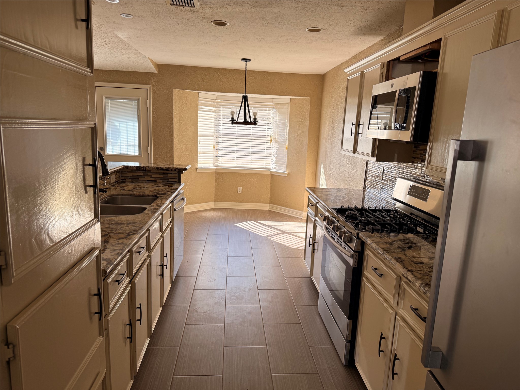 13726 Rampchester Lane Houston, TX 77015 - Photo 8 of 30 a kitchen with stainless steel appliances granite countertop a stove and a sink