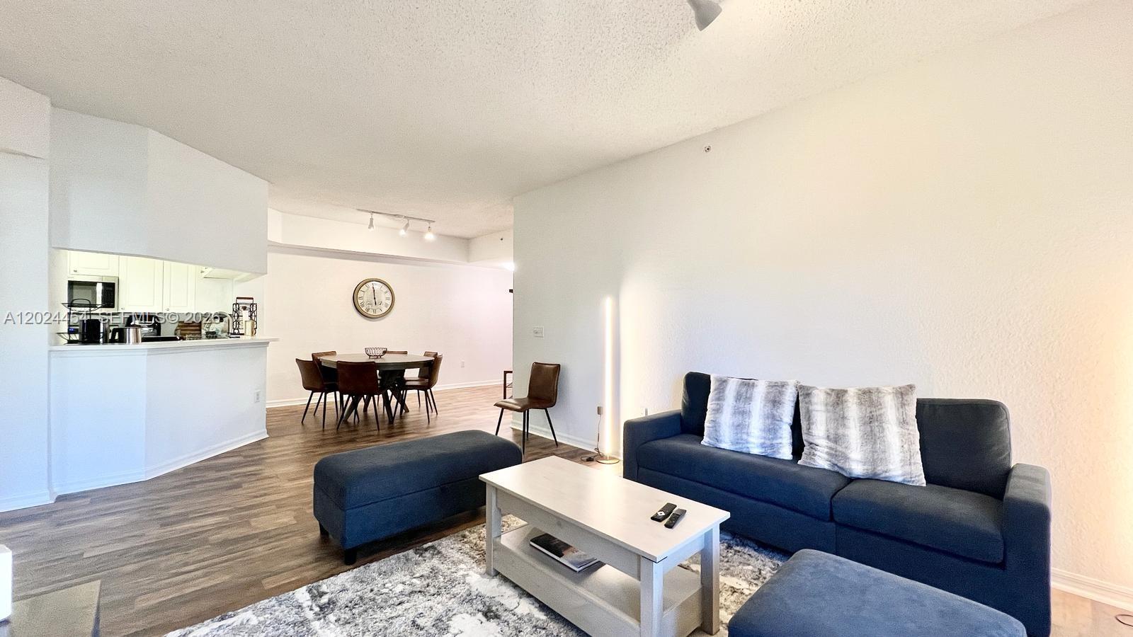 2727 Anzio Court, Unit 106 Palm Beach Gardens, FL 33410 - Photo 5 of 43 a living room with furniture and wooden floor