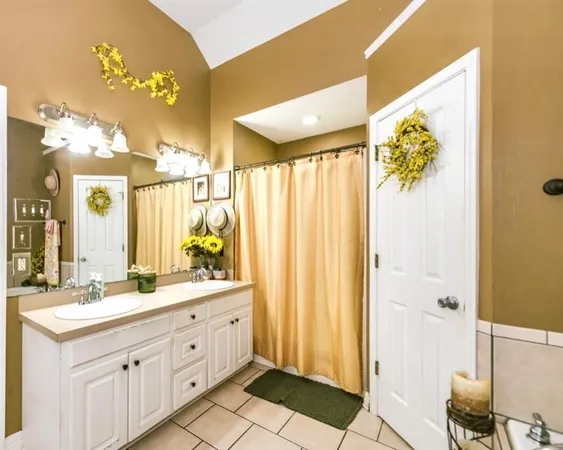 a bathroom with a double vanity sink and a mirror