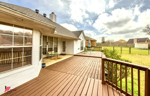 a view of a balcony with wooden floor