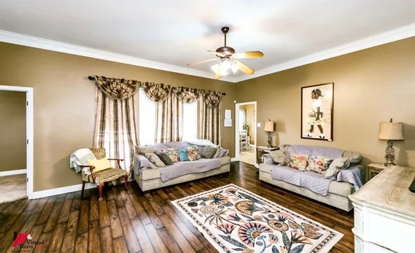 a living room with furniture and wooden floor