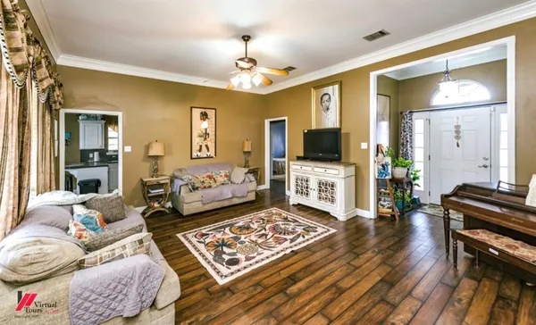 a living room with furniture and a flat screen tv