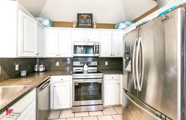 a kitchen with stainless steel appliances a stove microwave and a refrigerator